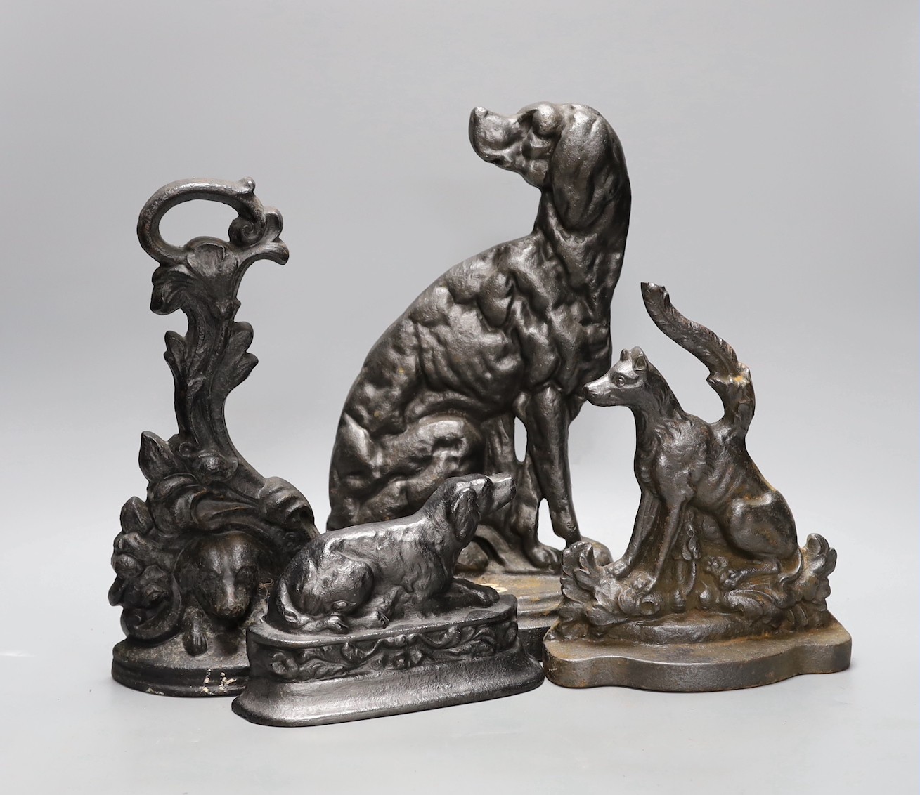 Four cast iron ‘dog’ door stops, 32cm